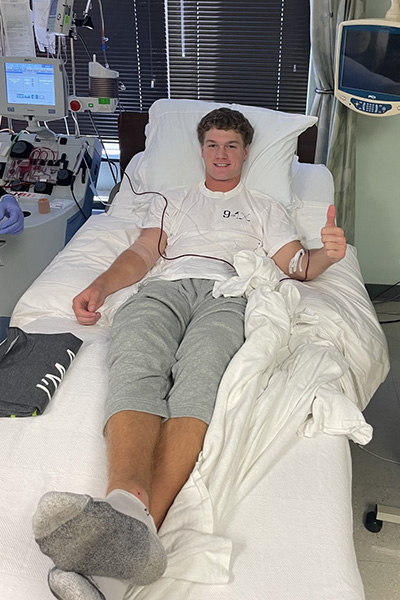 Peyton Lambert laying in a hospital bed