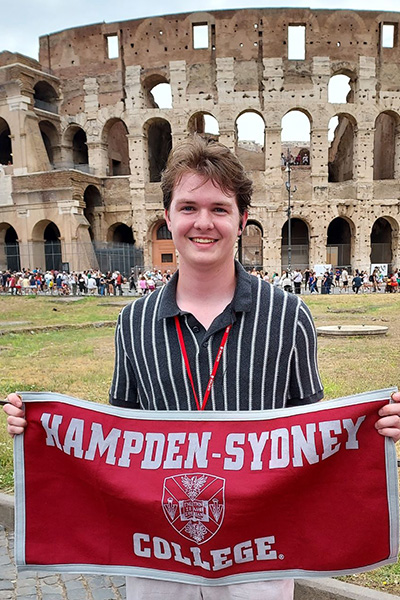 Scott Gipson ’26 standing in front of the Roman Coliseum