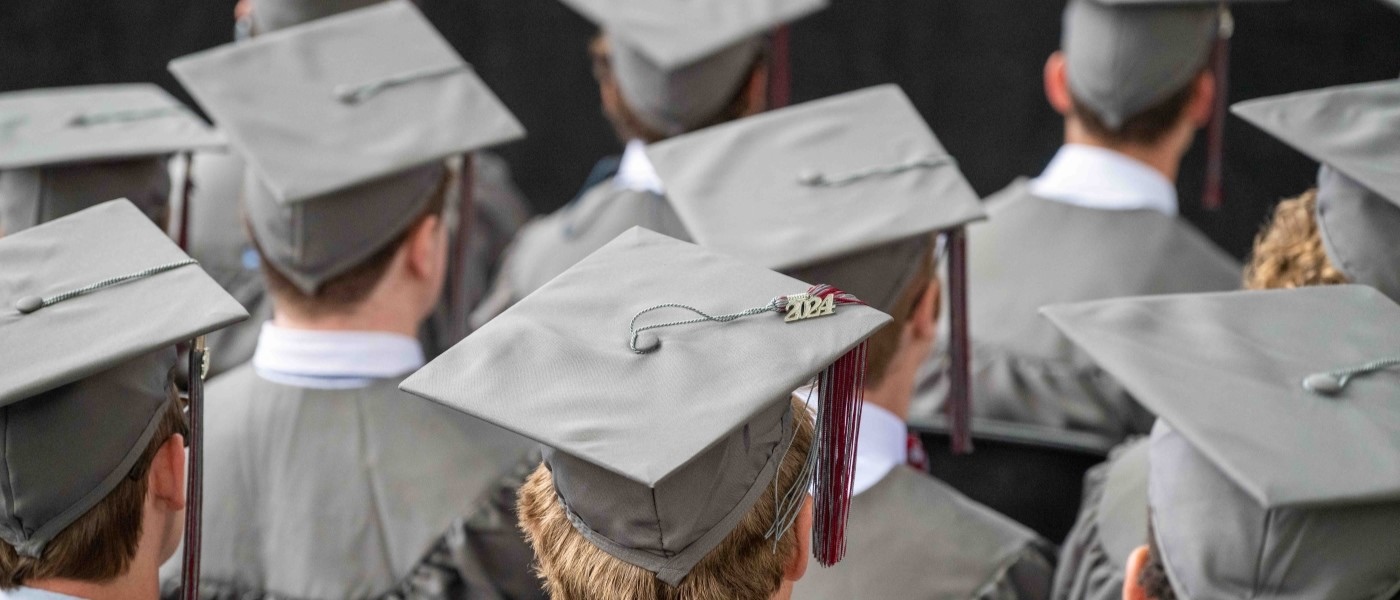 a close-up image of student heads wearing mortarboards at graduation
