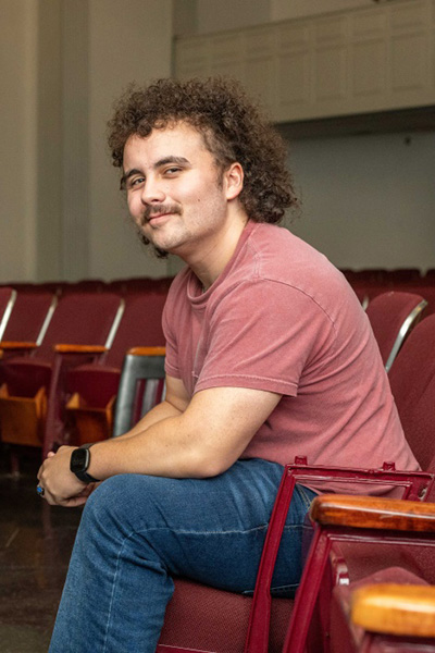 Student, Evin Burton '25 sitting in an auditorium
