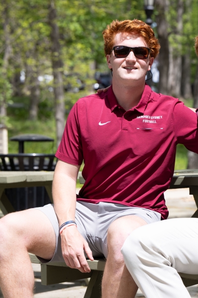 Sutton Lasso sitting at a picnic table talking