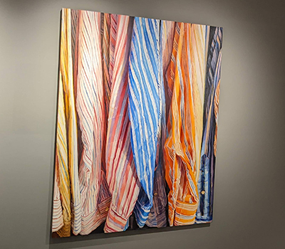 a painting of colorful men's shirtsleeves by Ray Kleinlein