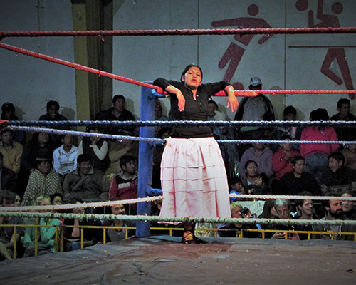 A Cholita wrestler rests between matches. Cholitas are indigenous women in Bolivia.