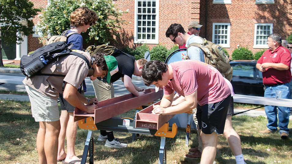 students signing a suport beam from Venable Hall