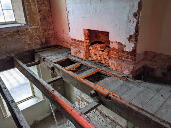 a view of the deconstructed interior of Venable Hall - brick, wooden beams and masonry