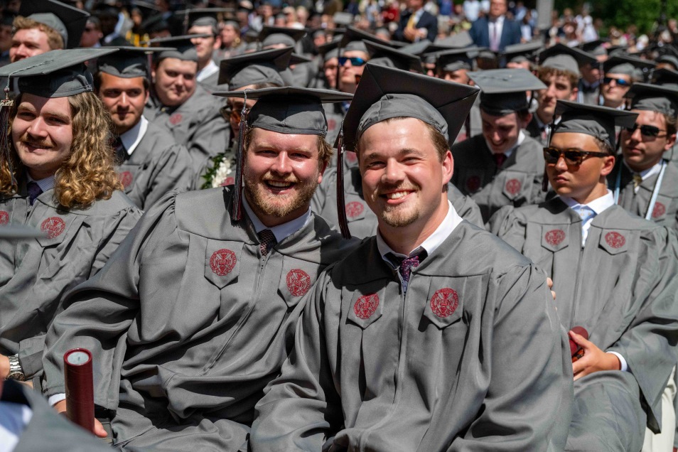 a crowd of graduates smiling