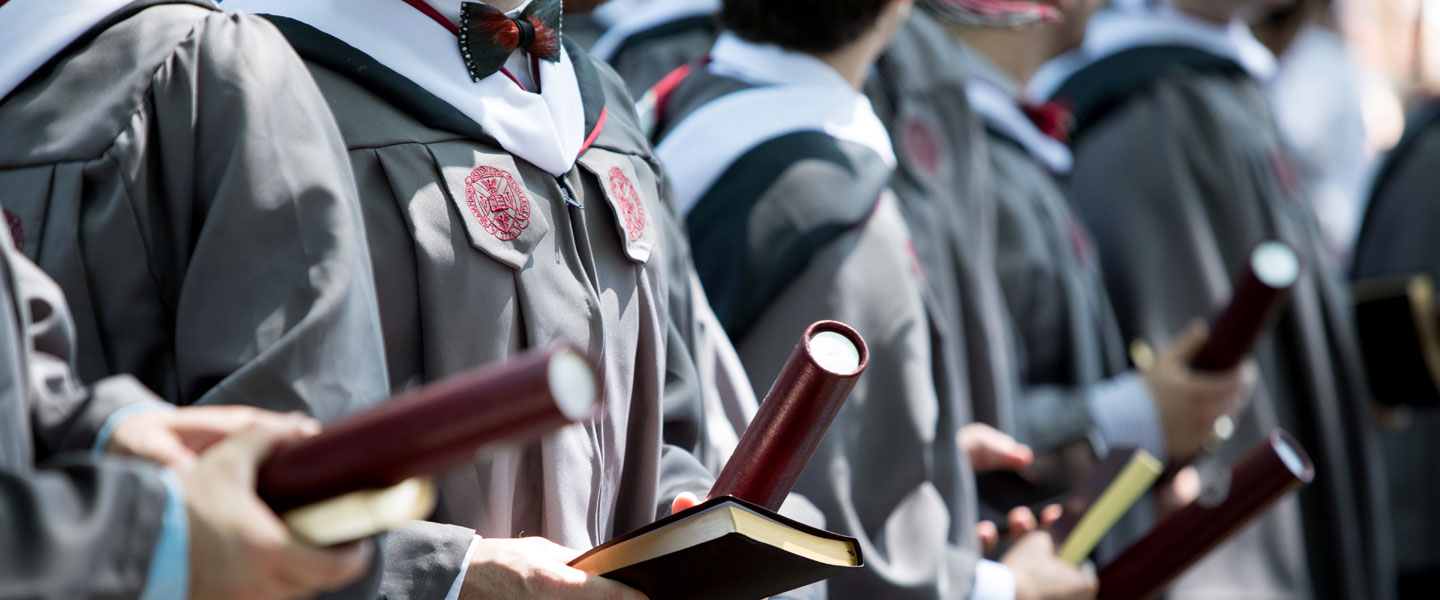 2018 graduates holding their degrees and Bibles at Hampden-Sydney College commencement