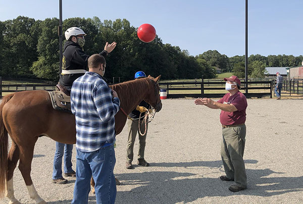 Hampden-sydney student volunteers introducing people to a horse
