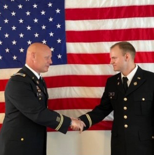 Colonel Anderson Sale '93 giving the oath of office to his son Lt. Mason Sale '20