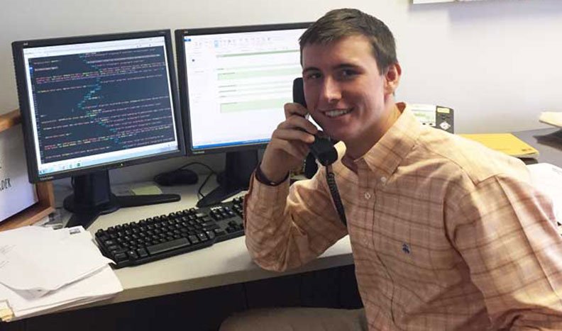 Tanner Beck talking on the phone in an office setting