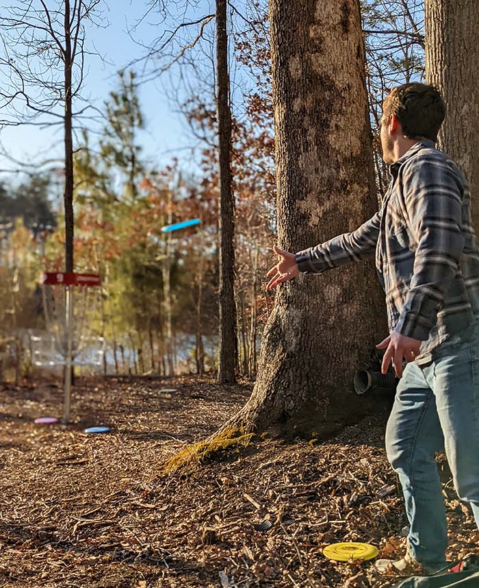 a man winding up to throw a disc