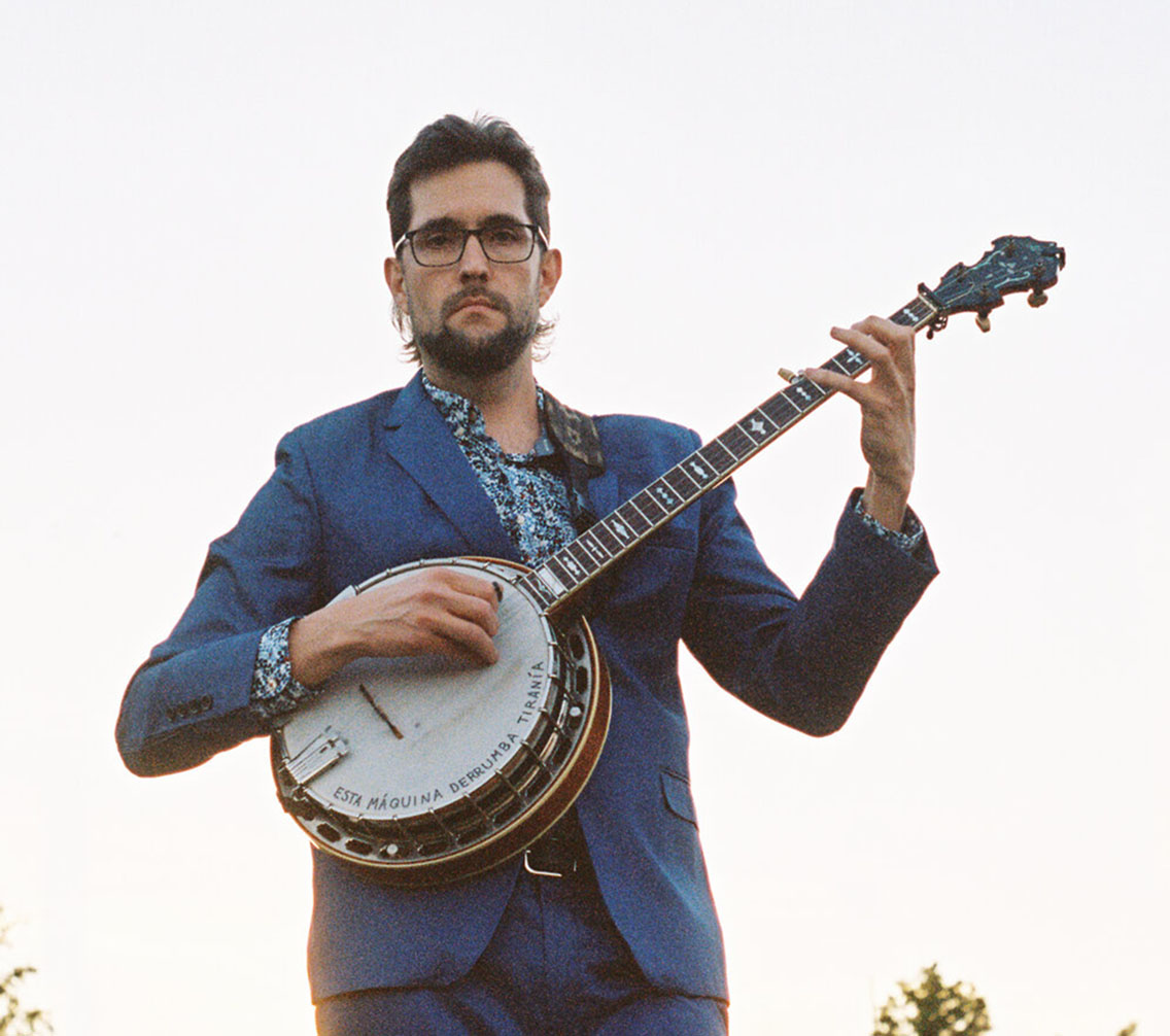 Joe Troop holding a banjo, photo by Kendall Bailey