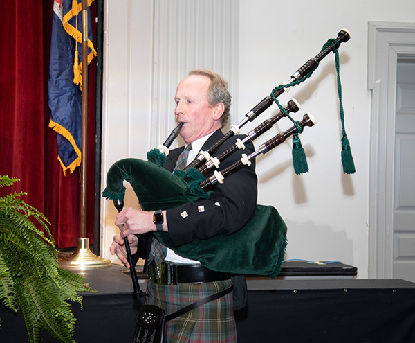 Dr. Stan Cheyne playing the bagpipes at convocation ceremony