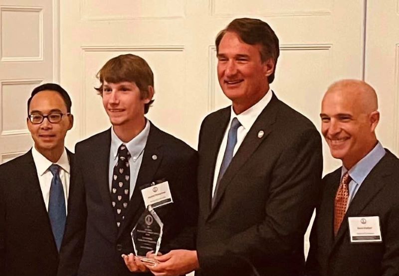 Justin Stimpson '23 accepting award from Governor Youngkin