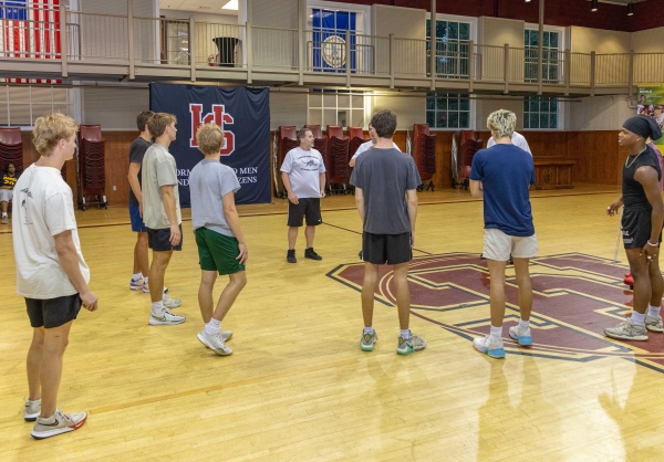 students and staff playing basketball together