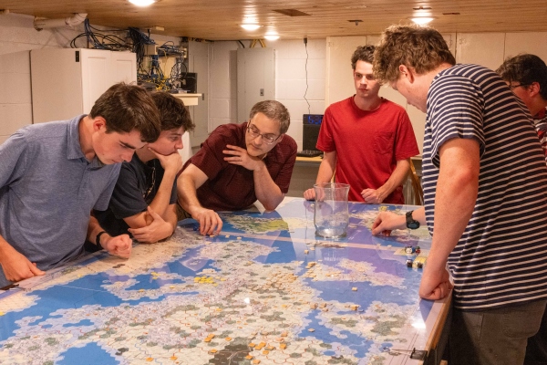 Dr. Marc Hight and students playing a strategy board game