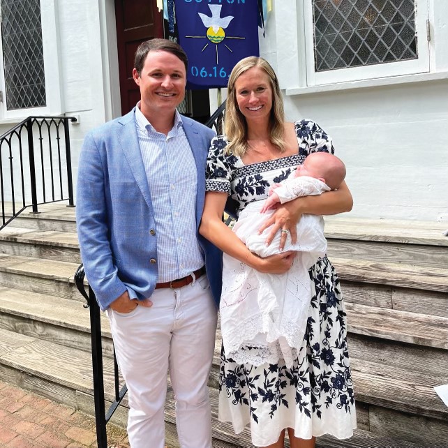 Carson Pitts and his wife holding their baby