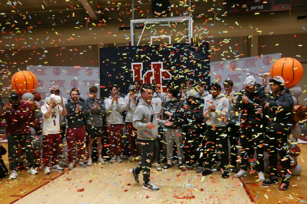 Tiger basketball players standing amidst confetti and decorations