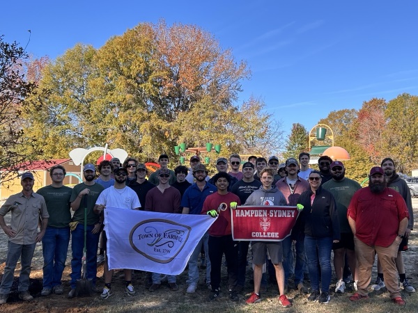 A large group of H-SC students, faculty and staff posing in front of the splash park