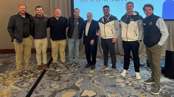 Football Coach Vince Luvara with team members and Get in the Game officials