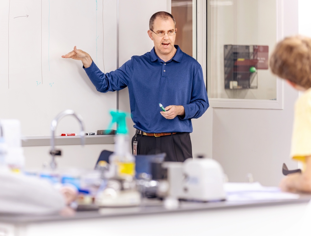 Dr. Hargadon standing in front of his student at a white board