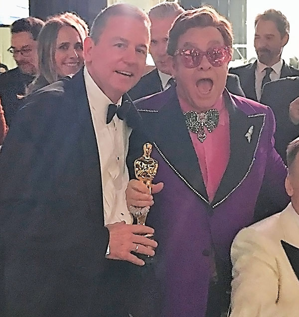 Barron Segar poses with friend, Elton John