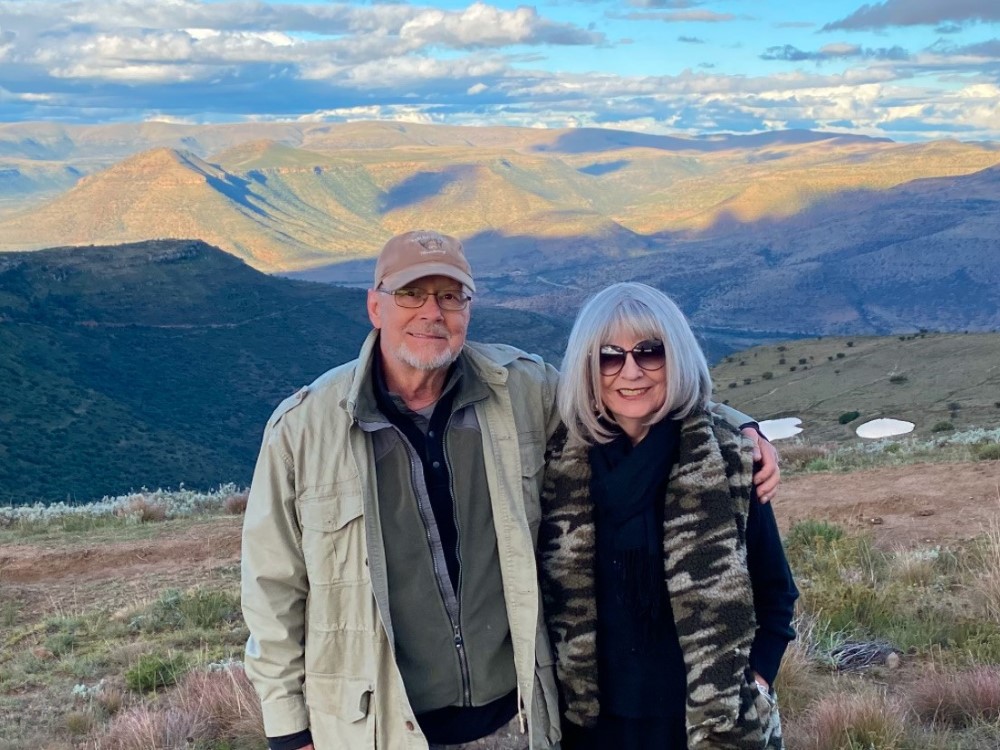 Pete Mowbray and wife standing in front of a mountian landscape