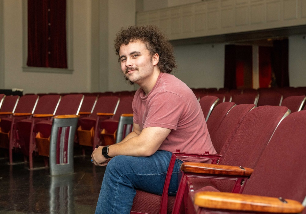 Student, Evin Burton '25 sitting in an auditorium