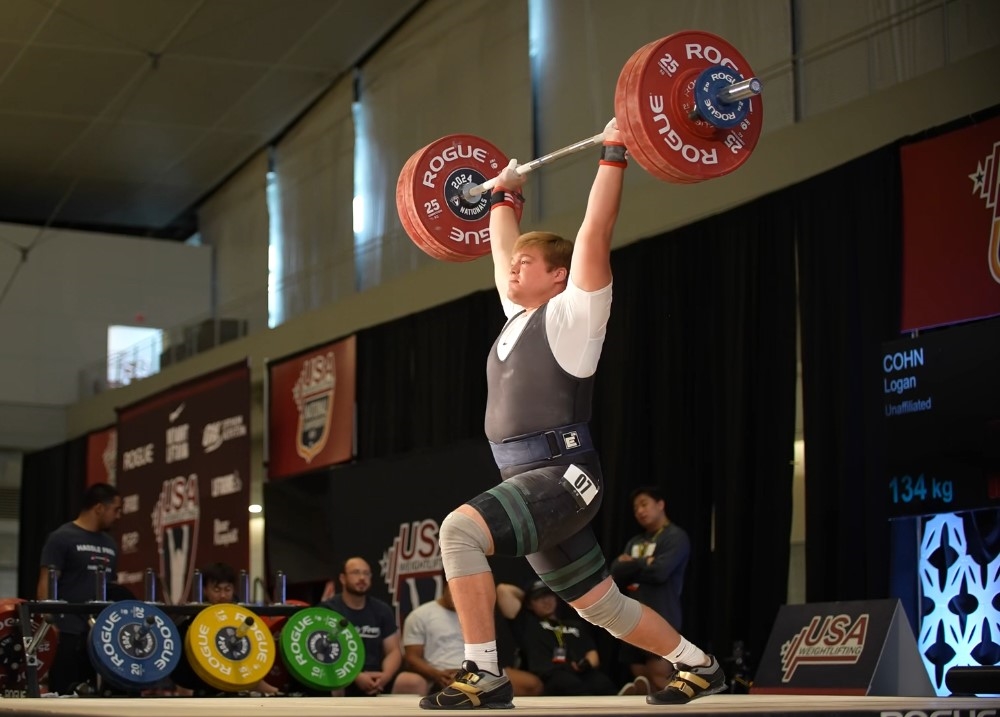 Logan Cohn '25 holding a barbell overhead