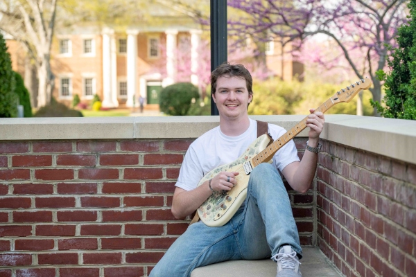 Scott Gipson ’26 playing a guitar