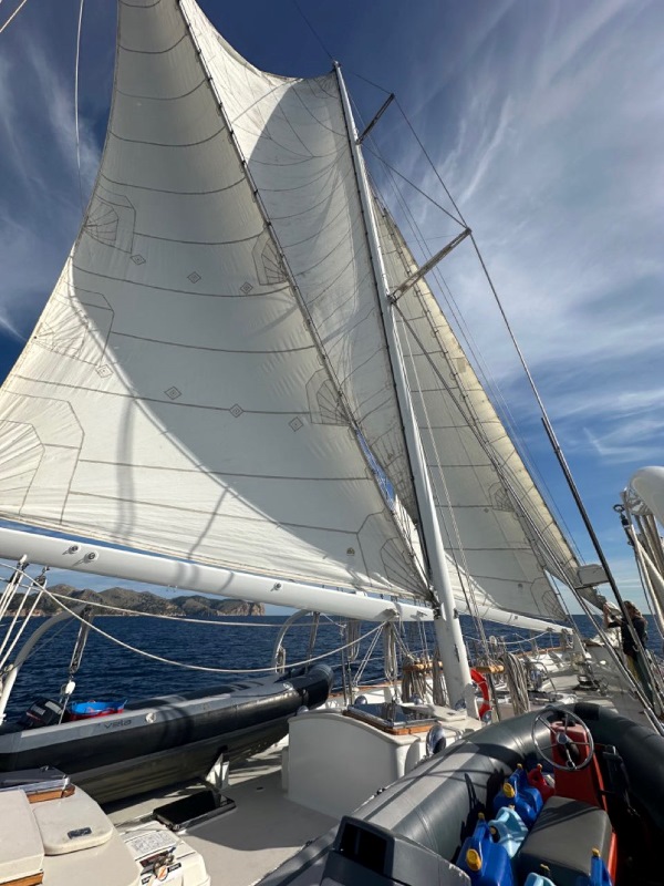 the sails fully open on a sailboat at sea