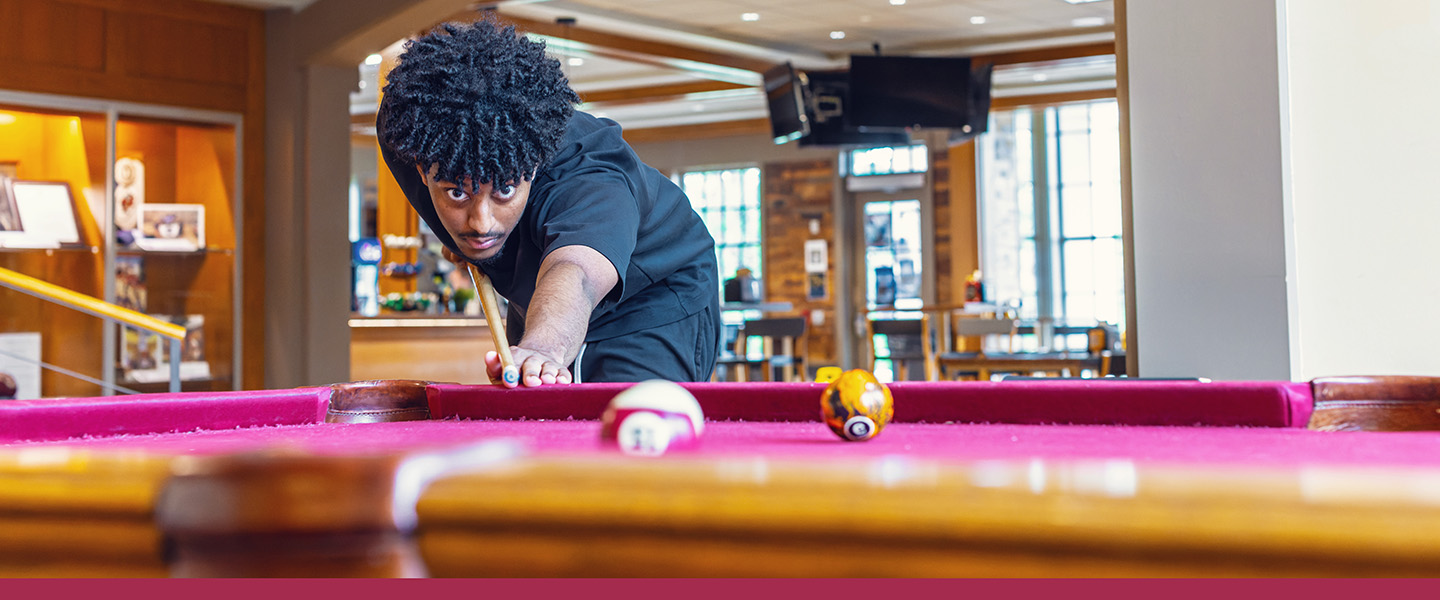 Hampden-Sydney College student playing pool in the Tiger Inn