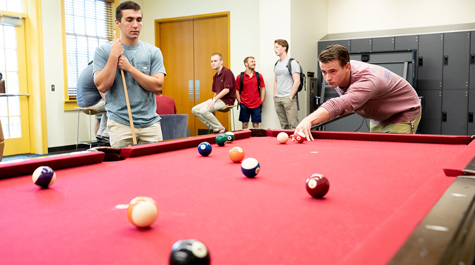 Student playing pool at Hampden-Sydney College