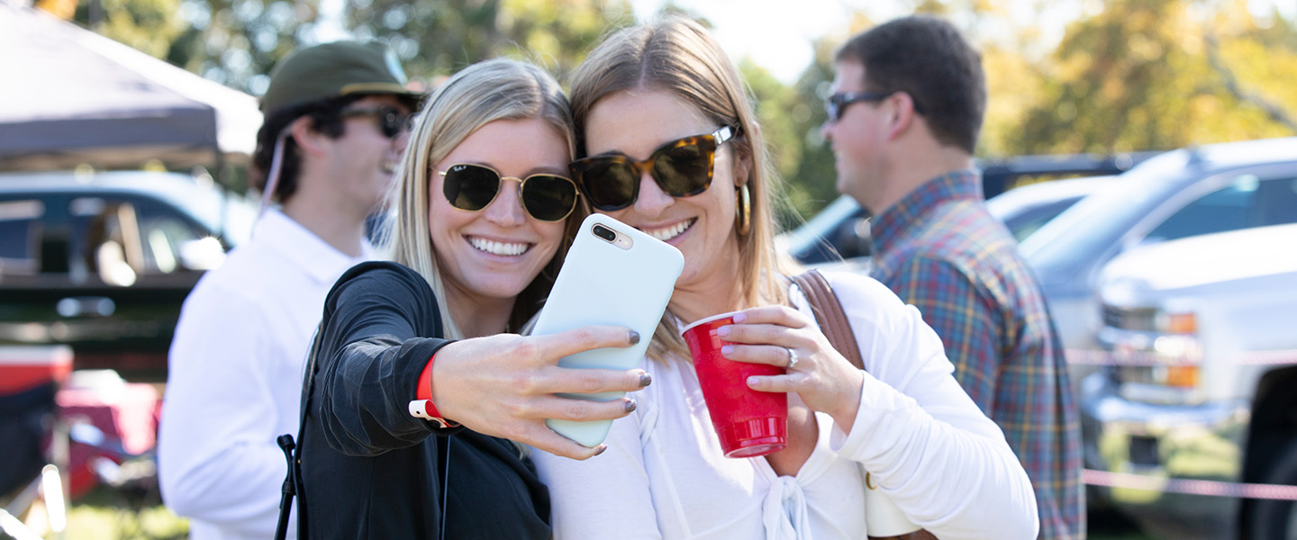 Women sharing a selfie at a tailgate at Hampden-Sydney College