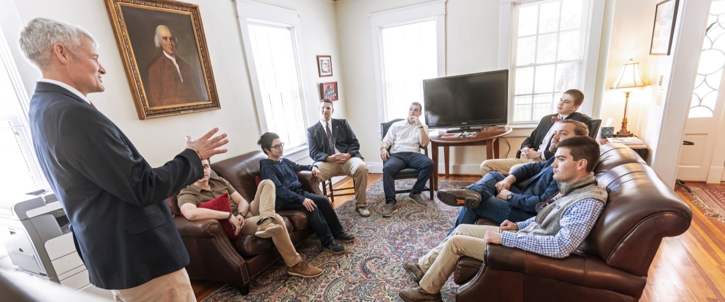 Director Vinton Bruton talks to a room full of young men